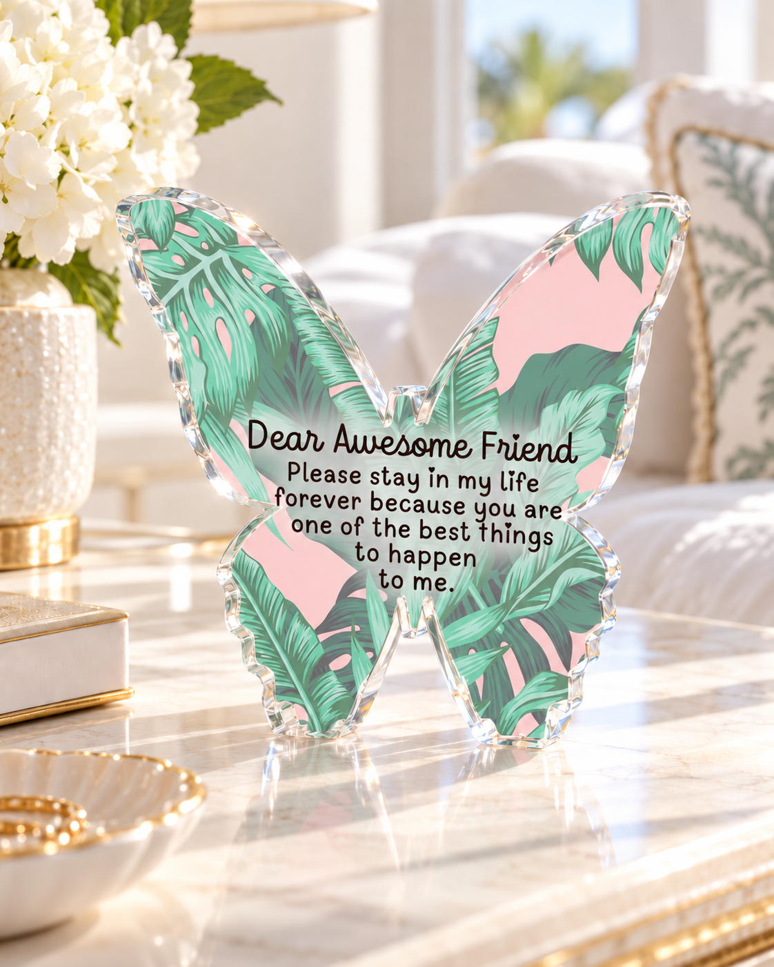 Palm leaf print acrylic butterfly desk weight displayed with books and decor