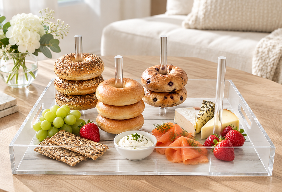 Bagels and donuts stacked on the dowels with fruit, crackers and dips in a living room