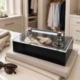Black acrylic box holding jewelry in a dressing room