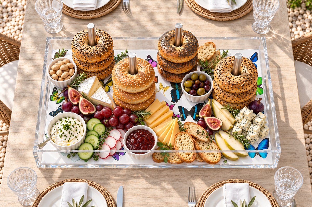 Overhead view of the butterfly bagel tray with bagel stacks, cheese, figs, grapes and crackers as a grazing board