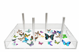 Butterfly acrylic bagel tray with four clear dowels, cutout handles and colorful butterflies on a white base, on white