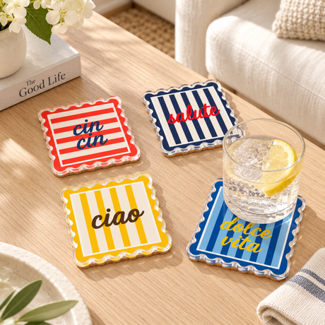 Scalloped striped coasters on a wood coffee table with a glass of lemon water