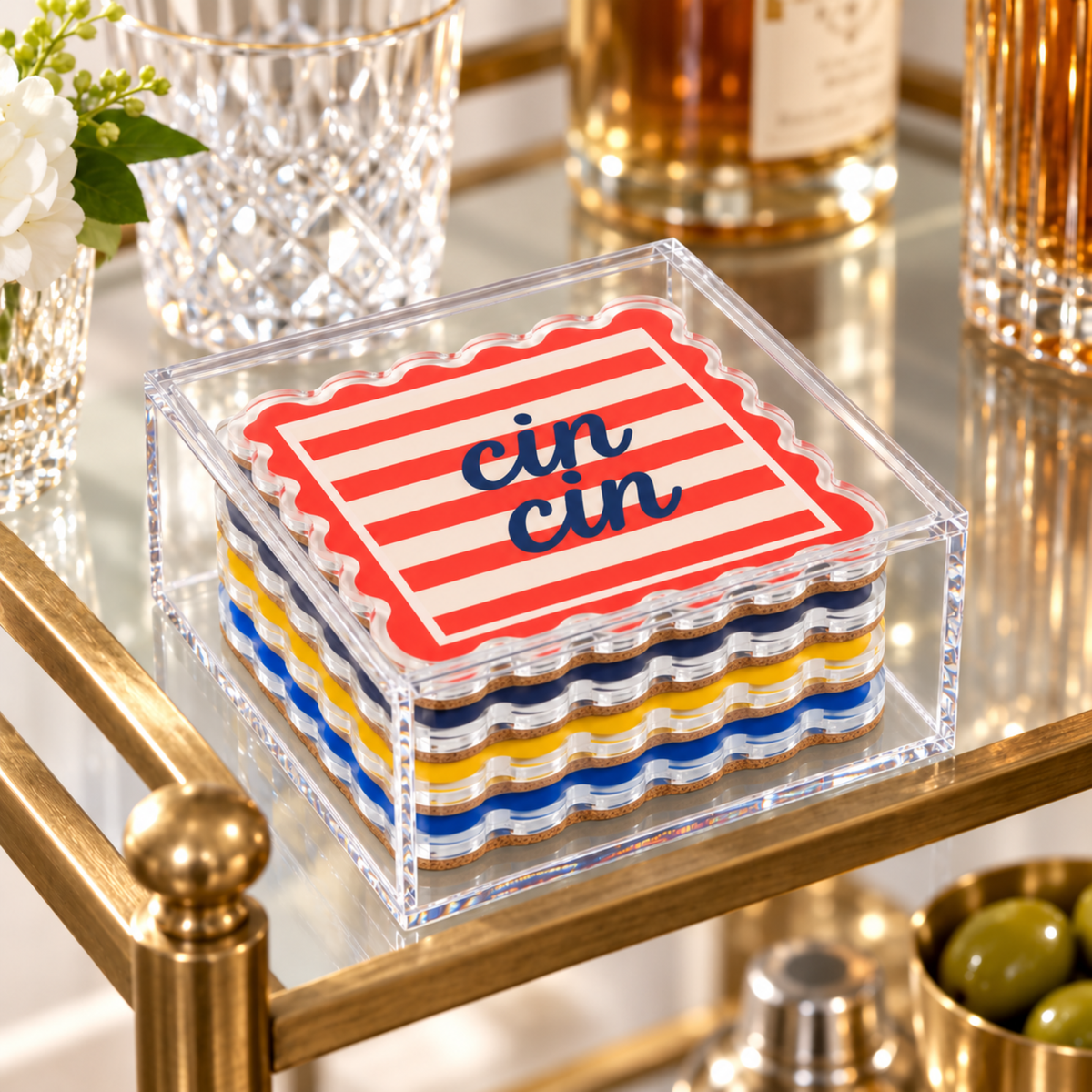Dolce Vita coaster set in its clear acrylic box on a gold bar cart