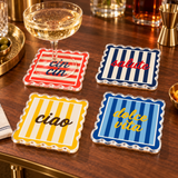 Cin cin, salute, ciao and dolce vita coasters on a dark wood table with a glass of white wine
