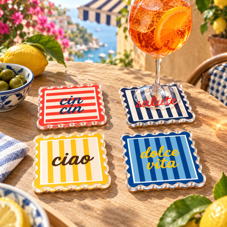 Striped acrylic coasters on a sunny terrace table with an Aperol spritz and lemons
