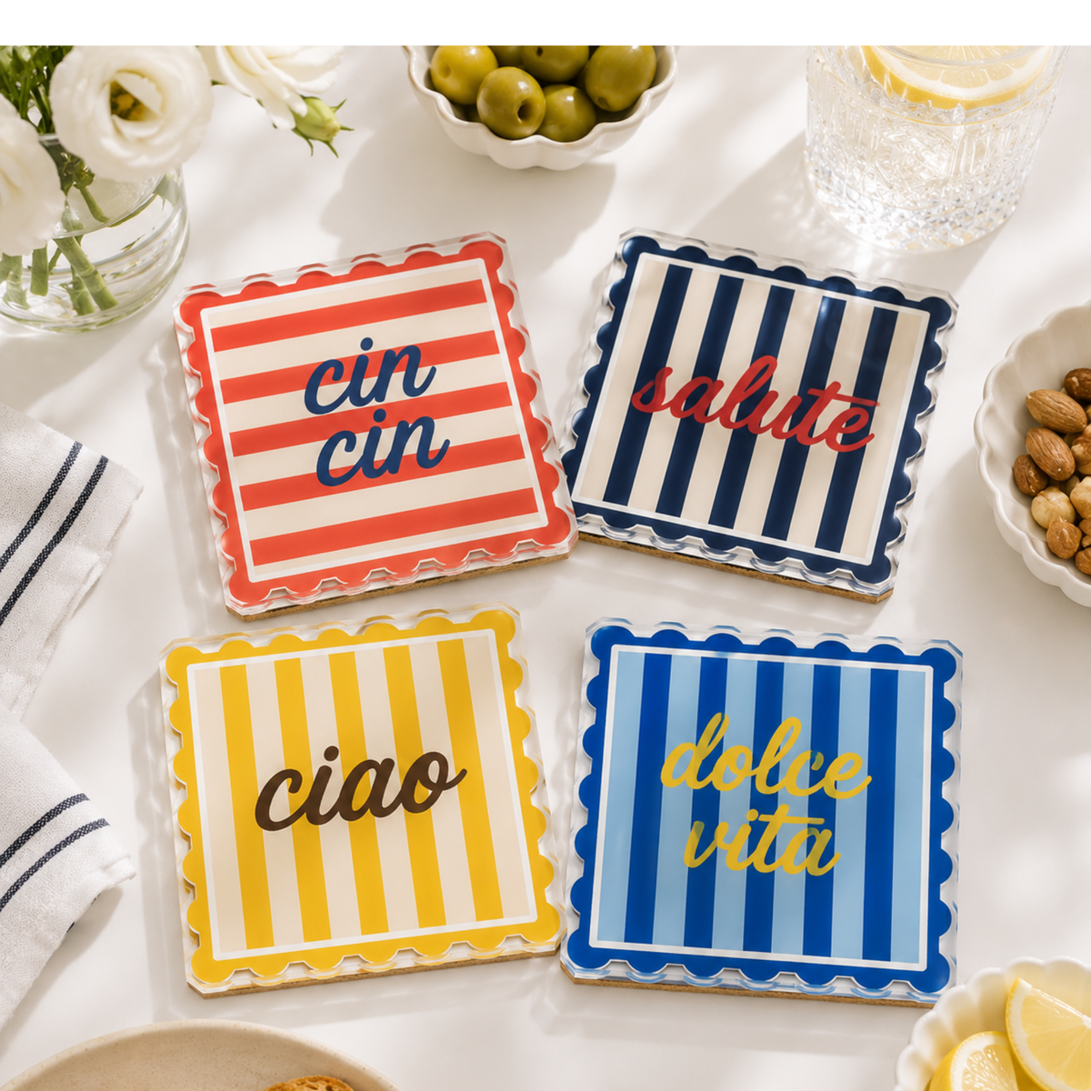 Striped acrylic coasters on a white table with olives and lemons