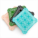 Four trellis coasters fanned out in peach, green, black and aqua