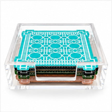 Low view of the coaster stack in its acrylic holder showing aqua, green, black and peach edges with cork backs