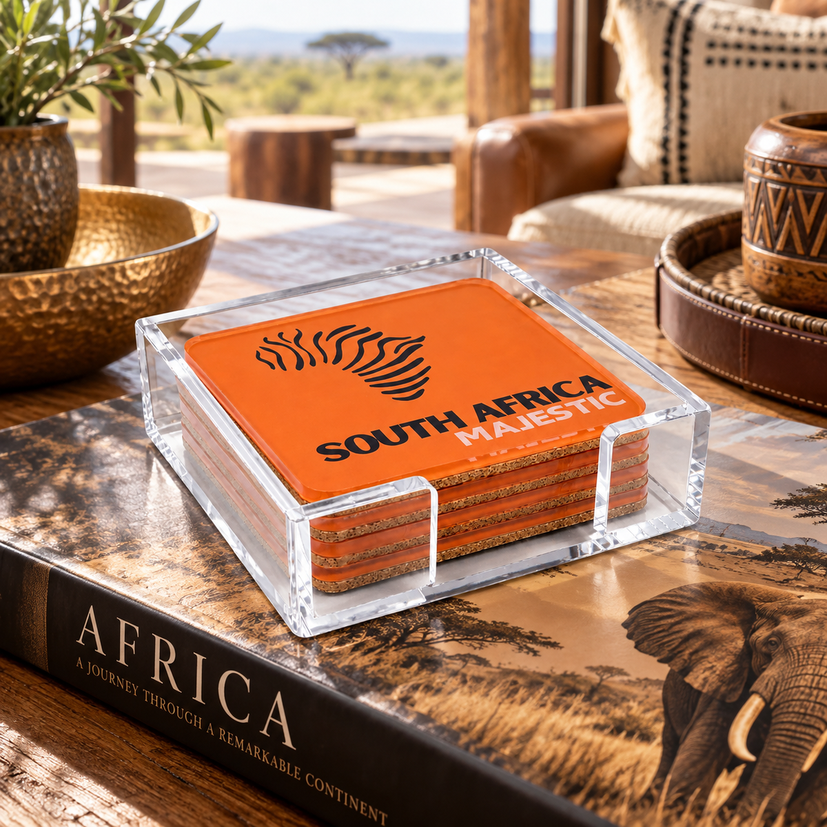 South Africa Bon Voyage acrylic coasters in their clear acrylic holder on a coffee table book in a safari lodge lounge
