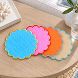 Cabana coasters fanned on a bleached oak table