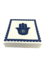Hamsa cocktail napkin design: a cobalt-blue hamsa with an evil eye in a navy scalloped border