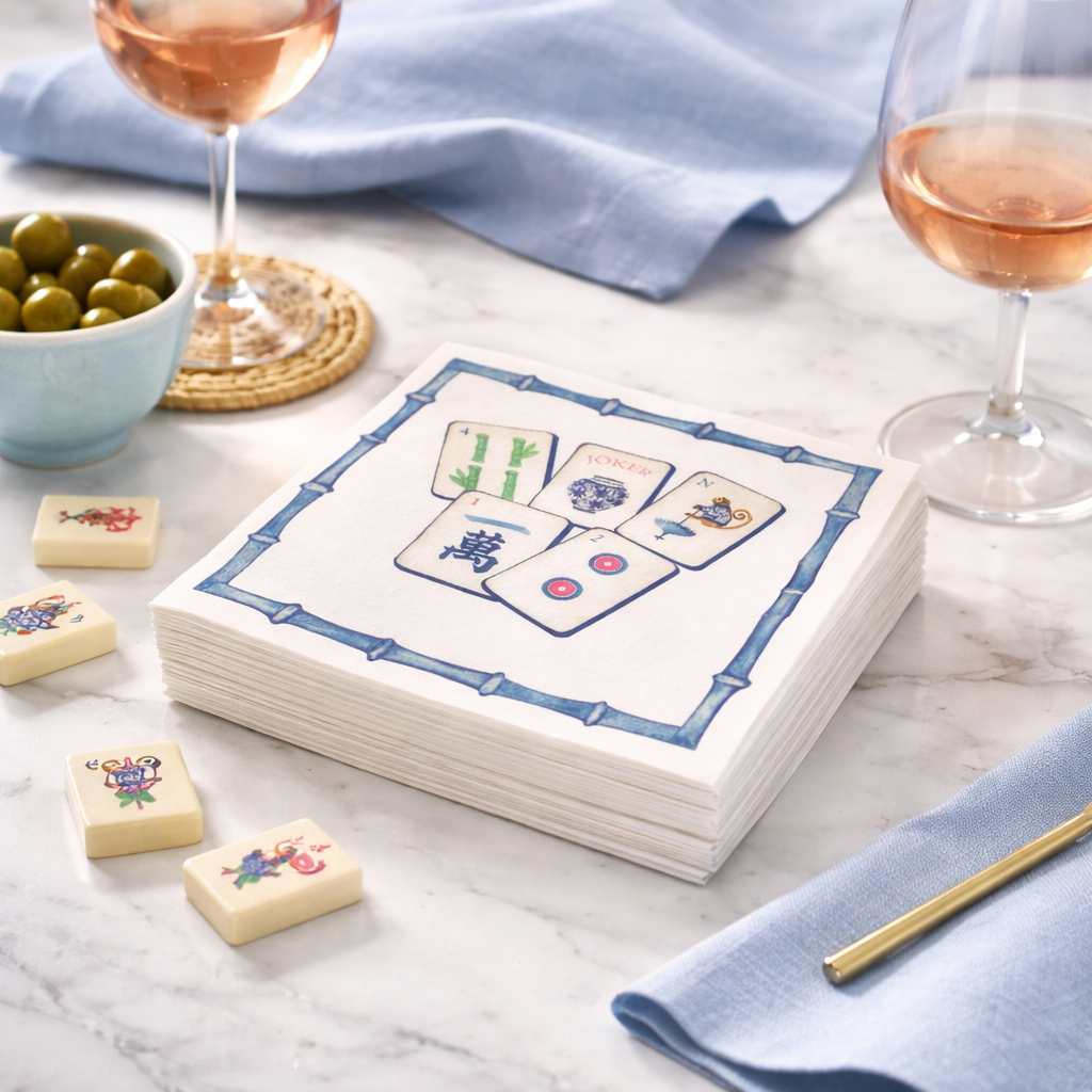 Linen-feel cocktail napkins printed with colorful mahjong tiles in a blue bamboo border