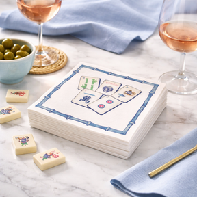Linen-feel cocktail napkins printed with colorful mahjong tiles in a blue bamboo border
