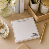 Keeping It Together, Mostly 5x5 notepad with gold border and SUV illustration on a desk