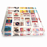 Clear Matchbox acrylic napkin weight on white, showing the collage of vintage-style matchboxes with lips, cherries, cocktails and a Lucky 8 through the thick acrylic