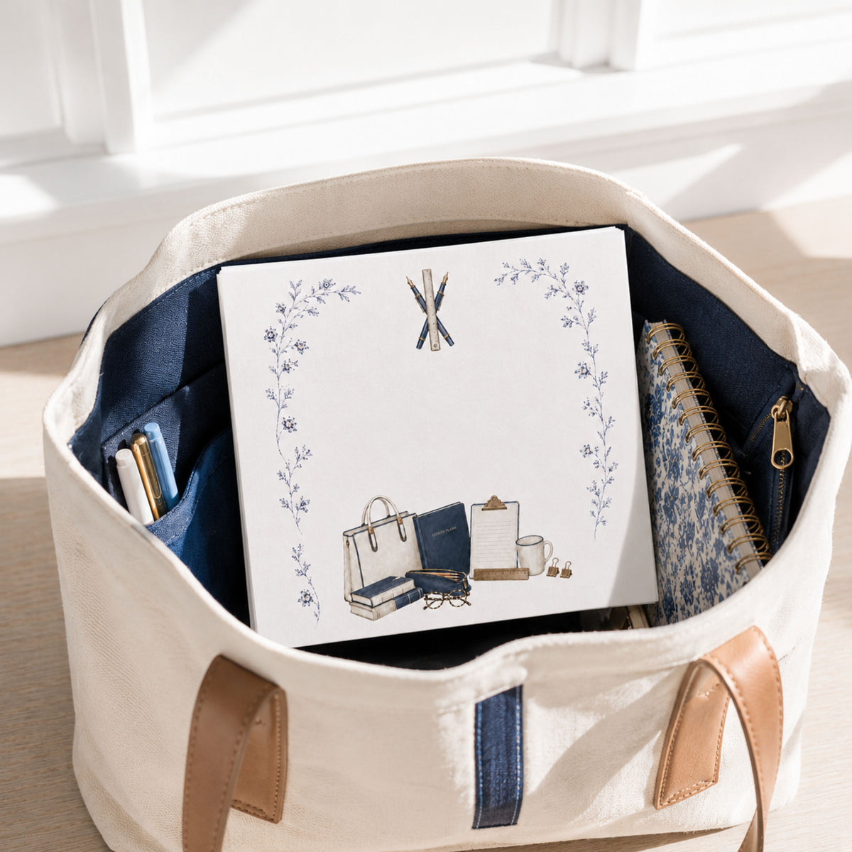Proper Teacher notepad in a canvas teacher tote with pens and a floral notebook