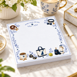 Proper Dogs After I Walk the Dog 5x5 notepad on a marble desk with a gold pen, blue-and-white teacup and white flowers