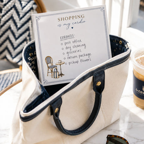 Shopping Is My Cardio notepad with a handwritten errands list in a canvas tote bag