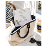 Shopping Is My Cardio 5x5 notepad with a handwritten errands list in a canvas tote on a marble cafe table with sunglasses