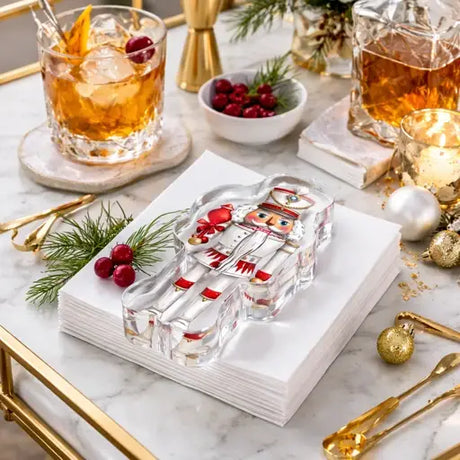 Nutcracker acrylic napkin weight with cocktails and cranberries, close-up